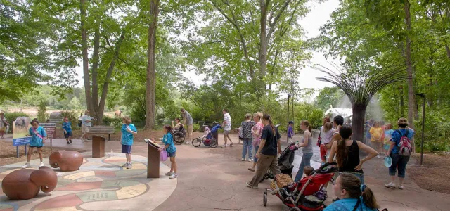 Large group of kids playing at Watani Grasslands on a game called Elephant Tracking,