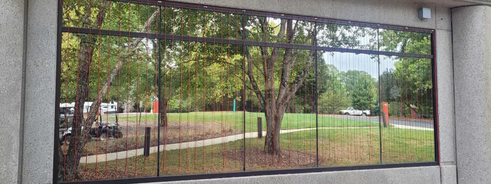 very reflective windows show the parking lot across the road