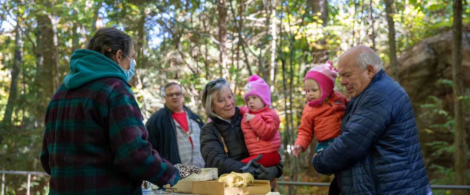 Grandparents with their twin grandchildren visit an investigation station.