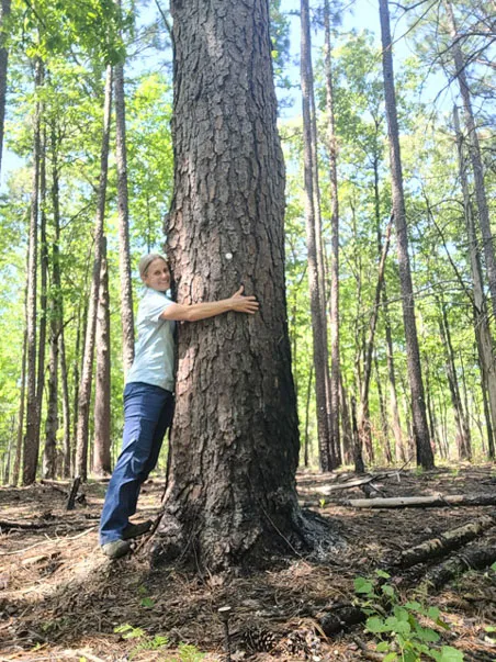 Betsy hugging a tree