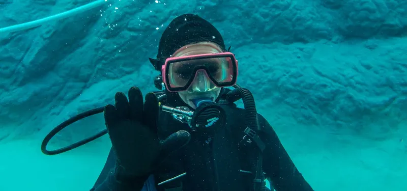 Keeper diving to clean animal habitat